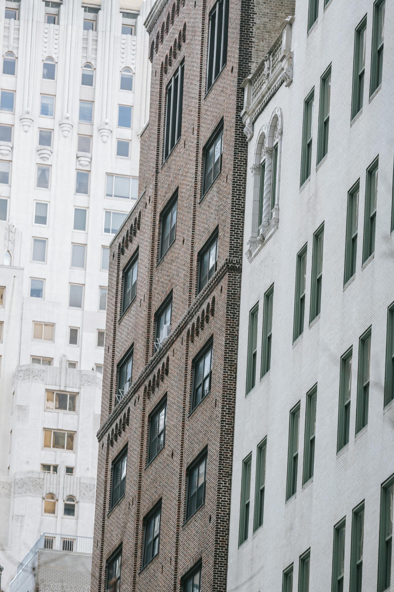 Low angle of tall multistory residential houses with windows located on street of city