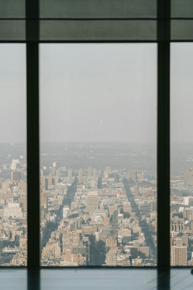 View through glass of tower on densely populated district with residential buildings in metropolitan